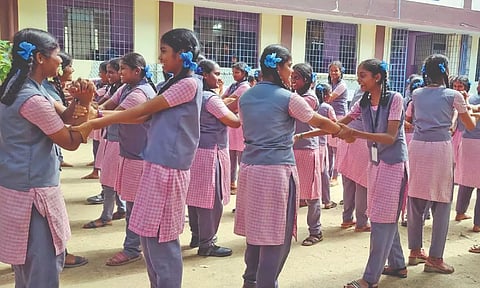 Students practising self-defence techniques in their school