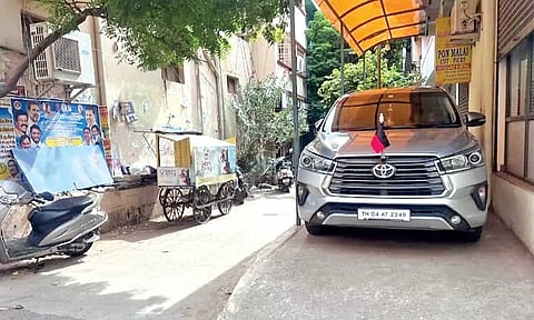 A car with DMK party flag parked on the illegally built ramp