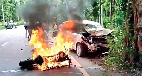 Two-wheeler on fire following the mishap on Mettupalayam-Ooty Road