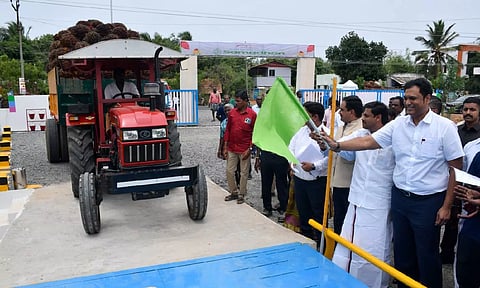 Minister TRB Rajaa flagging off vehicles distributed to farmers in Thanjavur on Monday