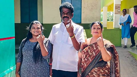 MLA C Sivakumar and family members show inked fingers at a polling station at Tiruvamathur on Wednesday
