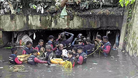 Kerala Fire and Rescue Services personnel during a search operation after a sanitation worker was swept away in rainwater while cleaning the Amayizhanchan canal on Saturday, in Thiruvananthapuram, Sunday, July 14, 2024. (Photo/PTI)