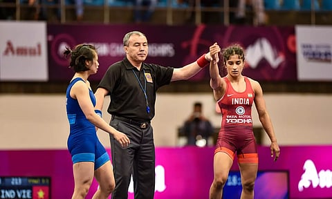 Referee raises the hand of Indian wrestler Vinesh Phogat after she defeated Thi Ly Kieu (PTI)