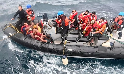 Indian Navy personnel with the rescued crew members of Comoros-flagged oil tanker MT Falcon Prestige that capsized off the Oman coast on Monday, amid the rescue operation (PTI)