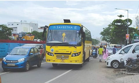 Cars encroach upon the road even as blue barricades take up the remaining portion of the pavement near the Retteri traffic signal