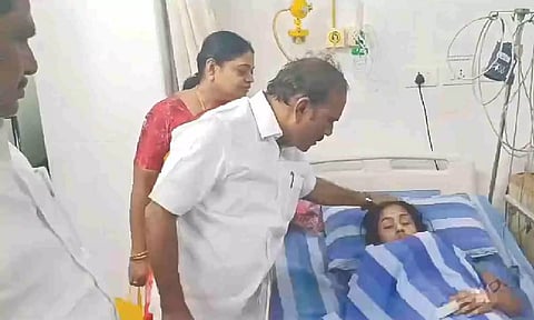 Labour Minister CV Ganesan checking on a victim's health in a Thoothukudi hospital