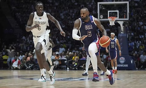 United States' forward LeBron James runs as he advances to score as South Sudan's center Khaman Maluach attempts to defend during an exhibition basketball game (AP)