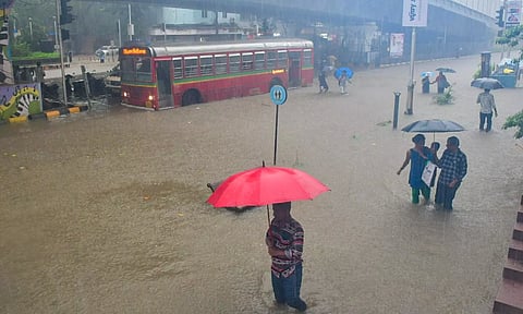 A bus moves on a waterlogged road during monsoon rain, at Parel in Mumbai (PTI)