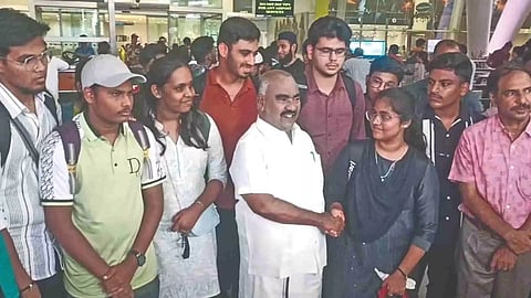 Minister KS Masthan with students who returned on Monday