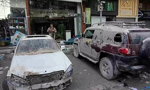 A Lebanese soldier, background, stands guards next to damaged cars at the scene during Israeli airstrike (PTI)