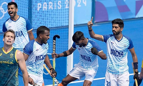 India's Shamsher Singh, left, and teammates jubilate on the end of the men's field hockey match between Australia and India (PTI)
