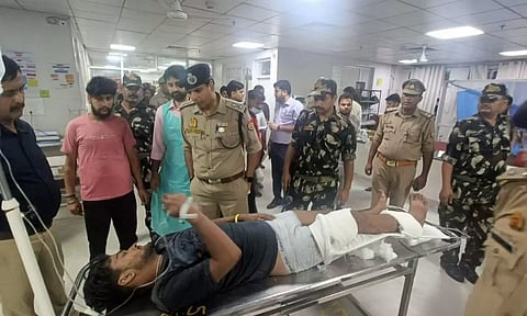 Policemen speak with an injured at a hospital after a collision between a double-decker bus and a car on Agra-Lucknow Expressway (PTI)