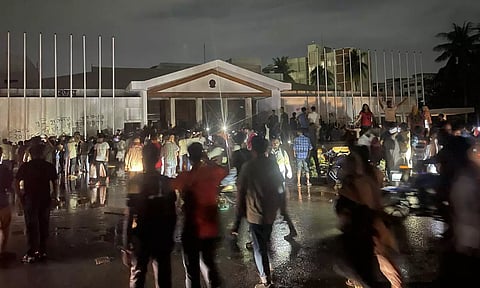 Bangladeshi people gather outside the prime minister's house in Dhaka