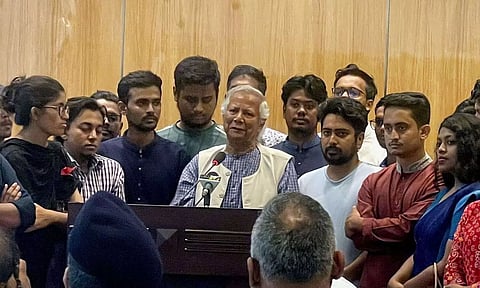 Nobel laureate Muhammad Yunus (C) speaks to the media in Dhaka (PTI)