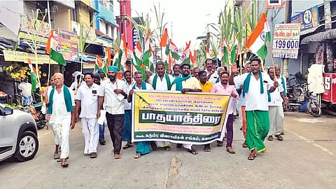 Farmers staging a rally for cane arrears in Kumbakonam on Thursday