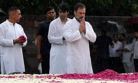 Congress leader Rahul Gandhi pays tribute to former prime minister Rajiv Gandhi on his birth anniversary, amid monsoon rain, at Veer Bhumi (PTI)