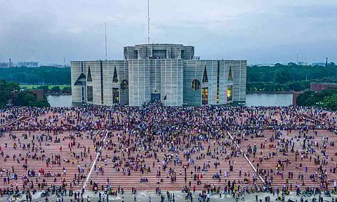 A photo taken with a drone shows people gather around at the Bangladesh Parliament House in Dhaka (PTI)