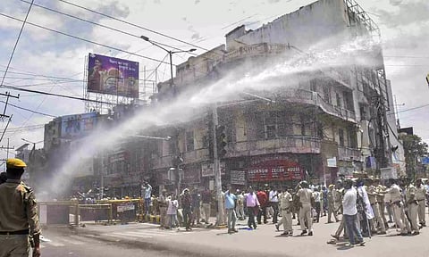 &nbsp;Police personnel use water cannon to disperse people protesting during the 'Bharat Bandh' called by SC/ST organisations over reservation issue (PTI)
