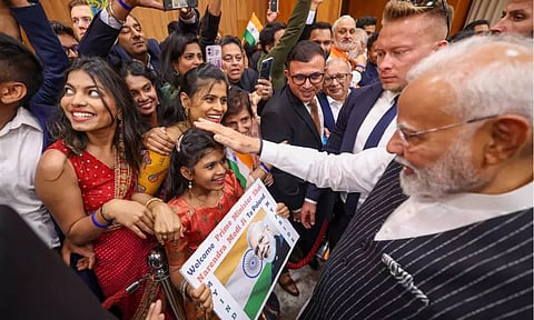 Prime Minister Narendra Modi interacts with the Indian community members upon his arrival, in Warsaw (PTI)