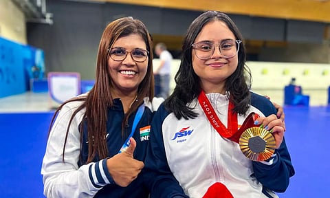 India's Avani Lekhara with her coach Suma Shirur poses for photos after winning the gold medal in the women's 10m air rifle (SH1) shooting event at the Paralympics 2024 (PTI)