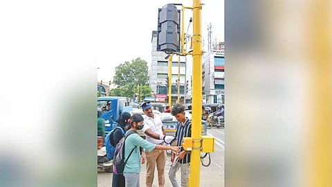 A traffic cop showing the public how to use the button