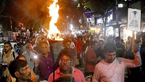 People take part in a protest march over the alleged sexual assault and murder of a trainee doctor (PTI)
