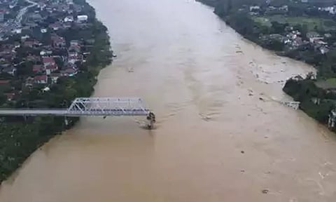 &nbsp;A bridge collapsed and a bus was swept away by flooding Monday as more rain fell following a typhoon in Vietnam (AP)