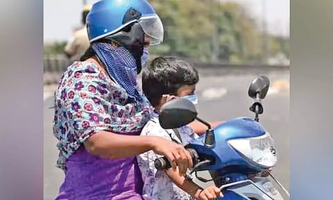 Children as pillion riders wearing helmets is rare in the city