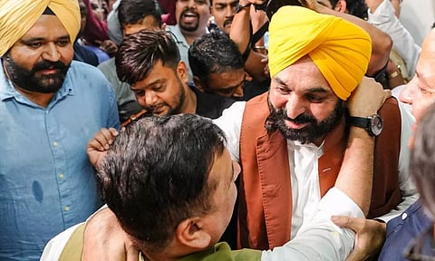 Punjab CM Bhagwant Mann and party leader Sanjay Singh greet each other during celebrations after Delhi CM and party chief Arvind Kejriwal was granted bail by the SC in the now-scrapped Delhi excise policy case, in New Delhi (PTI)