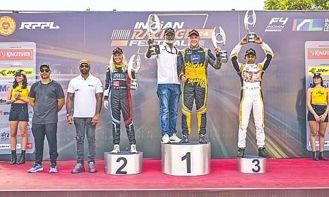 Gabriela Jilkova, Jon Lancaster (C), Ruhan Alva pose on the podium