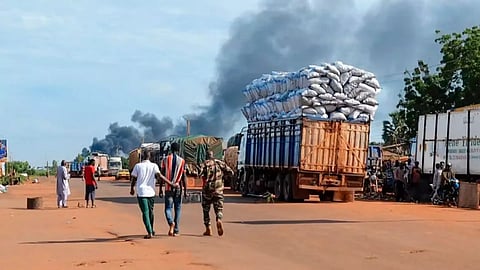 Malian security personnel detaining a man (AP)