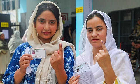 Voters show their fingers marked with indelible ink after casting their votes during the first phase of J&amp;K Assembly elections (PTI)