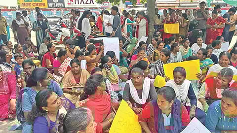 Parents sitting at the entrance of the school on Tuesday