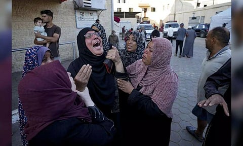 Palestinians mourn for relatives killed in the Israeli bombardment of the Gaza Strip at a hospital morgue (AP)