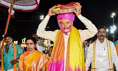 N Chandrababu Naidu carries silk clothes to present to Lord Venkateswara on behalf of the state government during Srivari Brahmotsavam at Tirumala temple (PTI)
