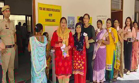 Voters queue up at a booth in Faridabad (ANI)