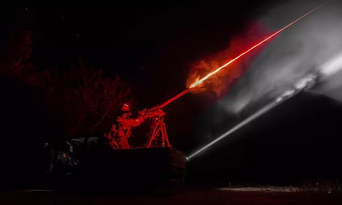 A Ukrainian serviceman of the 126th brigade air-defense unit fires by a machine gun during the training in Kherson region, Ukraine (AP)