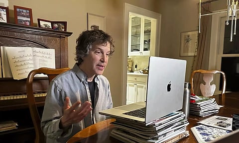American biochemist David Baker speaks to reporters at his home (AP)