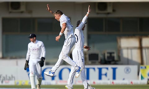 England's Brydon Carse, center, celebrates with teammate after taking the wicket of Pakistan's Mohammad Rizwan during the fourth day of the first test cricket match between Pakistan and England (PTI)