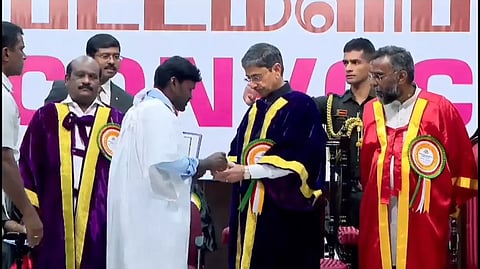 Student handing out a petition to Governor RN Ravi