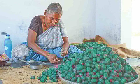 A worker engaged in making crackers in a manufacturing unit in Sivakasi in Virudhunagar district
