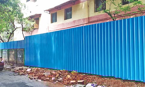 Metals sheets have replaced the collapsed compound wall of the Perambur school