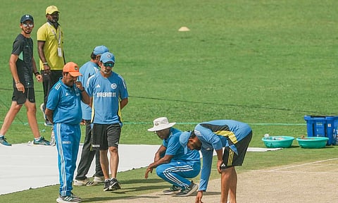 India's coach Gautam Gambhir and captain Rohit Sharma inspect the pitch during a practice session ahead of the second Test cricket match between India and New Zealand