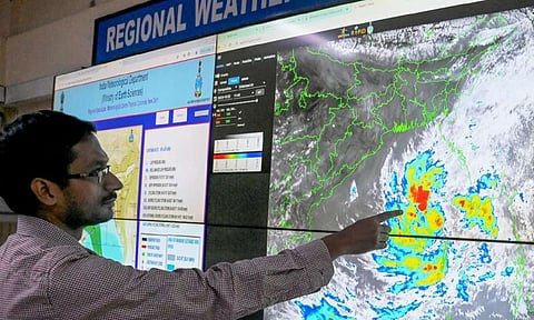 Scientist Sourish Bandopadhyay shows the progress of cyclonic storm 'Dana' at the RMC in Kolkata (PTI)