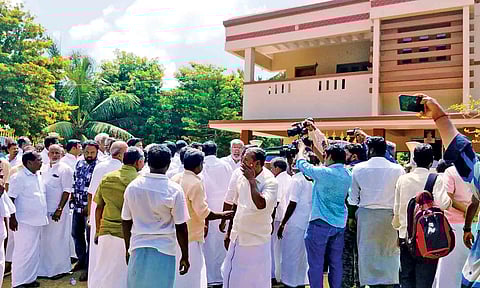 Supporters of R Vaithilingam gather outside his house at Thelungan Kudikadu in Thanjavur district