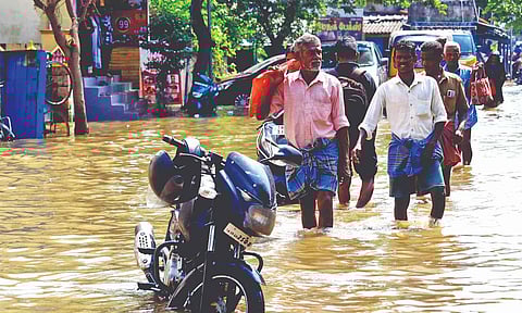 People wading through flooded road in Pandalkudi, Madurai after heavy downpour