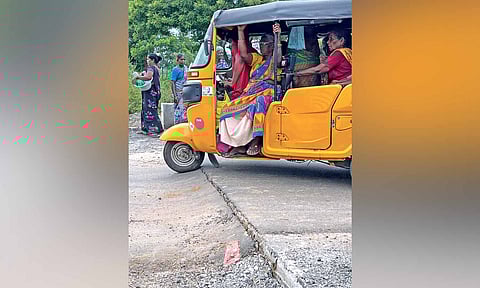 An autorickshaw struggling to alight from the poorly constructed bridge at JJ Nagar