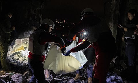 A medical emergency team carry the body of a teenager who died after a Russian drone attack in Kyiv on Oct 26, 2024 (AP)&nbsp;