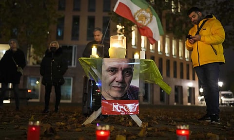 People commemorate Iranian-German Jamshid Sharmahd during a protest following his execution in Iran, near the Foreign Ministry in Berlin (AP )