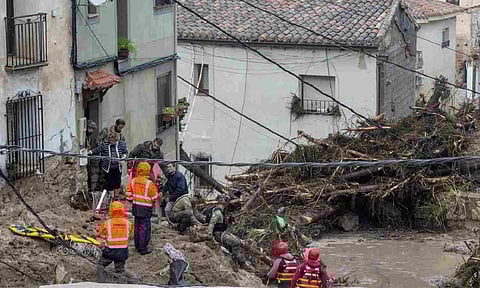 Members of the Spanish army and emergency services rescue people trapped in their homes after floods (AP)